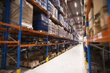 Interior of large distribution warehouse with shelves stacked with palettes and goods ready for the market. Interior of large distribution warehouse with shelves stacked with palettes and goods ready for the market.